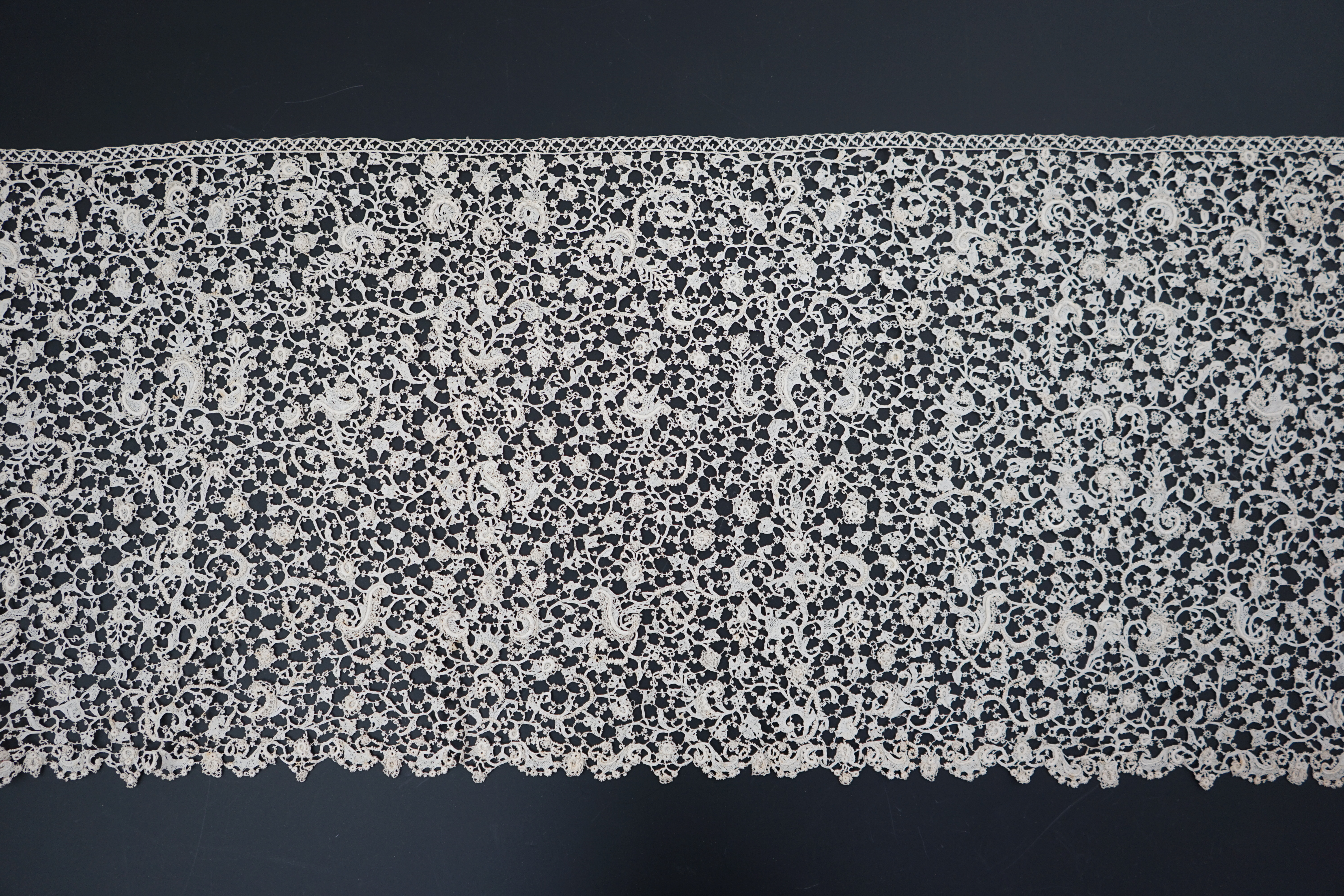 A rare 1680 (360cm length x 28cm deep) flounce of Point de neige, being an elaborate finely raised Venetian needle-point lace, a scaled down version of gros point, this flounce worked into tiny floral and leaf shapes, jo